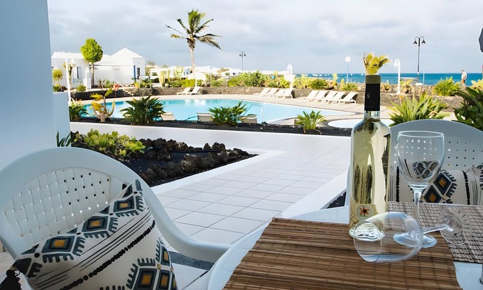 Arrieta House | Holiday Home 'Caleta Campos Bungalows' with Sea View, Shared Pool and Wi-Fi