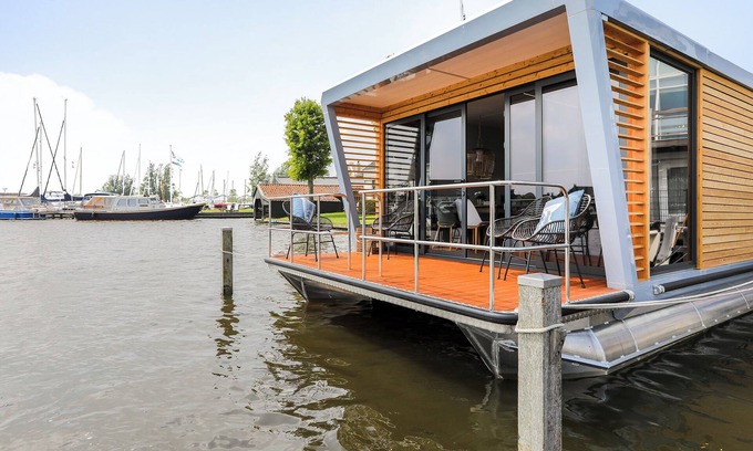 Grou Boat Rental | Houseboat Skoft with beautiful view over the water and on village Grou.