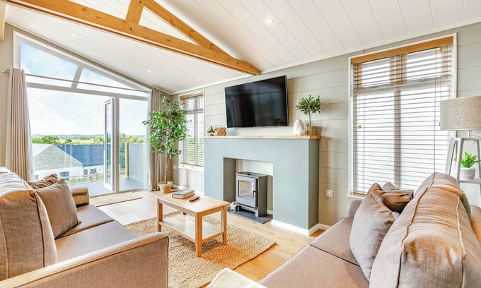 Middlezoy Ski Chalet | Luxurious lodge with vaulted ceilings and a welcoming feature fireplace.