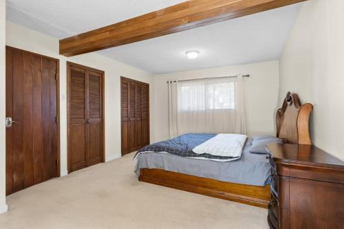 Ladner House | Master bedroom with spacious bathroom