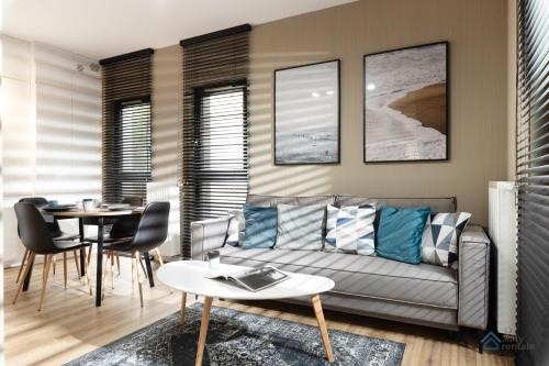 Dziaki Lesne Apartment | Modern Beige and Grey 3city Apartment in Gdynia by Noclegi Renters