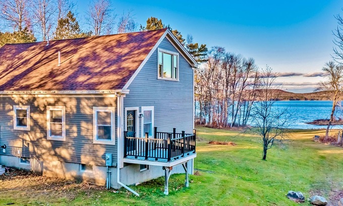 Belfast House | Ornate lake view home with wraparound deck, dock access & W/D