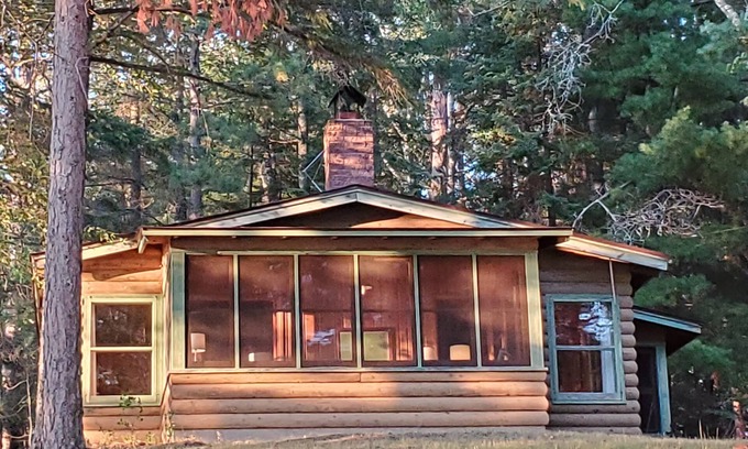 Bigfork Cabin | Rustic cabin in remote wooded area on point overlooking lake.