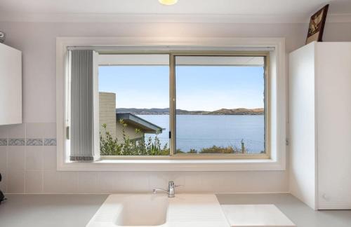 Sandy Bay House | Seaside Serenity: Panoramic Waterfront Retreat