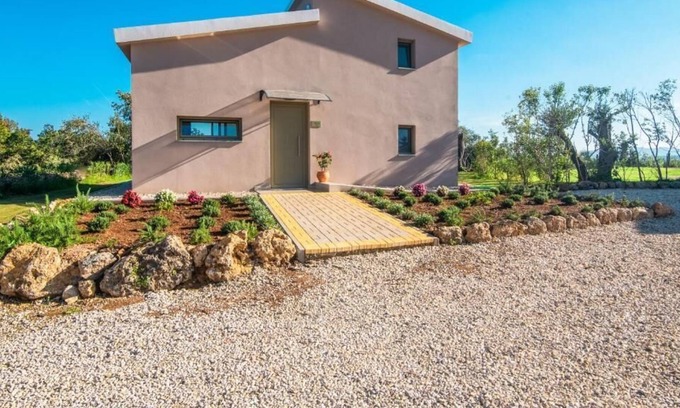 Doukades Villa | The villa's large private garden leads directly to the outdoor private pool.