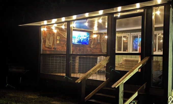 Fairhope Cottage | This inviting outdoor living space is an extension of the home,