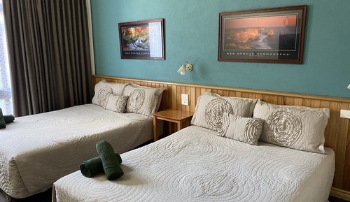 Room 12: Standard Two Queens with 50 inch Smart TV located on Ground Floor
