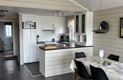 Lindesnes House | Holiday home Mona in Lussevika, new addition 2024, near Spangereid-Lindesnes, southern Norway, , max. 6 adults, own boat mooring, approx. 100 m² living space, 3 bedrooms, charming and tasteful furnishings, large veranda with fjord view, terrace f.