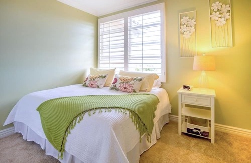 Beach Barber Tract House | Two-story house with lush, enclosed backyard for outdoor living & beach gear