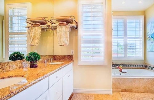 Beach Barber Tract House | Two-story house with lush, enclosed backyard for outdoor living & beach gear