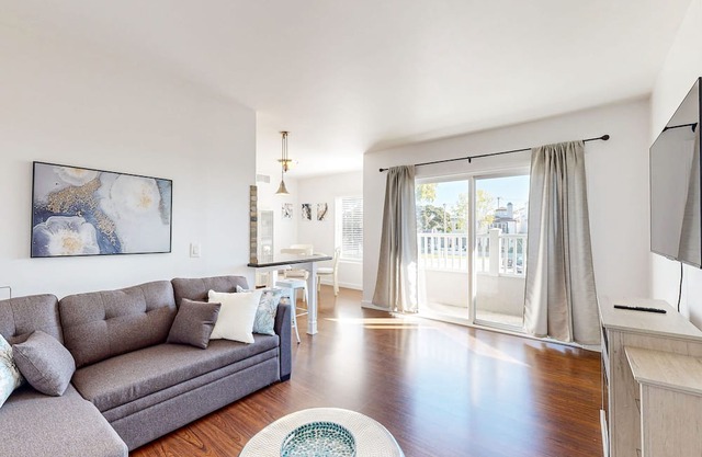 Sunny condo by the beach with a full kitchen, balcony, & water view