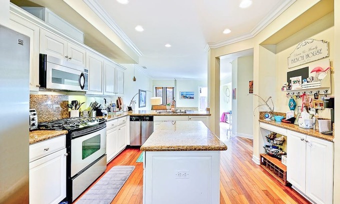 Beach Barber Tract House | Two-story house with lush, enclosed backyard for outdoor living & beach gear